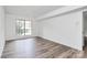Simple bedroom featuring a large window and wood-look flooring at 10432 Camelback Cir, Charlotte, NC 28226