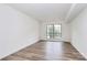 Minimalist bedroom with a large window and wood-look flooring at 10432 Camelback Cir, Charlotte, NC 28226