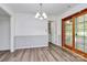Open dining area features modern lighting, neutral wall paint, and wood-look flooring at 10432 Camelback Cir, Charlotte, NC 28226