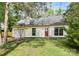Inviting one-story home with a manicured lawn and an attached garage, set beneath mature trees at 10432 Camelback Cir, Charlotte, NC 28226