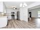 Modern kitchen featuring stainless steel appliances, white cabinetry, and an adjacent dining area at 10432 Camelback Cir, Charlotte, NC 28226