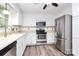 Modern kitchen featuring stainless steel appliances, white cabinetry, and light countertops at 10432 Camelback Cir, Charlotte, NC 28226