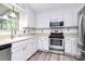 Modern kitchen featuring stainless steel appliances, white cabinetry, and light countertops at 10432 Camelback Cir, Charlotte, NC 28226