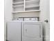Bright laundry room with a washer, dryer, and upper white cabinets for storage at 10432 Camelback Cir, Charlotte, NC 28226