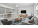 Comfortable living room with plush seating, a modern ceiling fan, and neutral décor at 10432 Camelback Cir, Charlotte, NC 28226