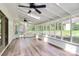 Spacious sun room with ceiling fans, skylights, and wood-look flooring at 10432 Camelback Cir, Charlotte, NC 28226