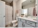 Bathroom featuring a gray vanity, a shower with a curtain, and neutral-toned tile at 1079 Sage Pine Cir, Clover, SC 29710