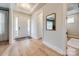 Bright foyer with hardwood floors and a view of the front door. Features a trey ceiling at 1079 Sage Pine Cir, Clover, SC 29710