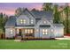 Charming gray two-story home with a front porch, well-manicured lawn, and attached garage at 1079 Sage Pine Cir, Clover, SC 29710