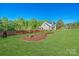 Expansive front yard with lush green grass and professionally landscaped flower beds at 1079 Sage Pine Cir, Clover, SC 29710