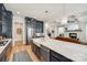 Open kitchen with a marble island, navy cabinets, and seamless flow into the living area at 1079 Sage Pine Cir, Clover, SC 29710