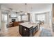Spacious kitchen island with marble countertop, a farmhouse sink, and stylish pendant lighting at 1079 Sage Pine Cir, Clover, SC 29710