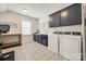 Well-equipped laundry room with modern appliances, dark cabinets, and unique flooring at 1079 Sage Pine Cir, Clover, SC 29710