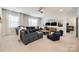 Spacious living room with a large sectional sofa, big windows, and stylish decor at 1079 Sage Pine Cir, Clover, SC 29710
