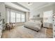 Bright main bedroom with neutral tones, plush bedding, and large windows at 1079 Sage Pine Cir, Clover, SC 29710
