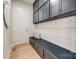 Convenient mudroom with storage bench, hooks, and stylish gray cabinetry at 1079 Sage Pine Cir, Clover, SC 29710