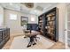 This modern office features custom shelves, natural light, and hardwood flooring at 1079 Sage Pine Cir, Clover, SC 29710