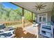 Covered porch with comfortable seating, a ceiling fan, and a view of the lush greenery at 1079 Sage Pine Cir, Clover, SC 29710