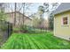Well-kept backyard features a lush lawn and a black fence, offering privacy and security at 110 Shamrock Ne St, Concord, NC 28025