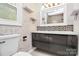 Modern bathroom with gray vanity, decorative tile accents, and elegant fixtures at 110 Shamrock Ne St, Concord, NC 28025