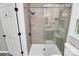 Stylish bathroom featuring a glass-enclosed shower with neutral tile and contemporary fixtures at 110 Shamrock Ne St, Concord, NC 28025