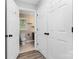 Hallway view into a bathroom featuring a toilet and sink with neutral and earthy decor at 110 Shamrock Ne St, Concord, NC 28025
