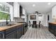 Inviting dining area with stylish black cabinets, wood countertop, modern table, and a view of the deck at 110 Shamrock Ne St, Concord, NC 28025