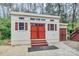 Exterior view of home and detached shed with red doors and shutters in the backyard at 110 Shamrock Ne St, Concord, NC 28025