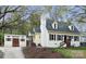 Charming yellow home with a white chimney, complemented by a detached garage and beautifully landscaped front yard at 110 Shamrock Ne St, Concord, NC 28025