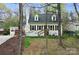 Charming home with light yellow siding, black shutters, and well-maintained landscaping at 110 Shamrock Ne St, Concord, NC 28025
