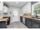 Modern kitchen featuring two-tone cabinets, wood countertops, stylish backsplash, and stainless steel appliances at 110 Shamrock Ne St, Concord, NC 28025