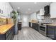 Modern kitchen featuring two-tone cabinets, wood countertops, stylish backsplash, and stainless steel appliances at 110 Shamrock Ne St, Concord, NC 28025