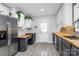 Modern kitchen featuring two-tone cabinets, wood countertops, stylish backsplash, and stainless steel appliances at 110 Shamrock Ne St, Concord, NC 28025