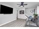Cozy living room featuring sleek gray flooring, ceiling fan, and a modern entertainment setup at 110 Shamrock Ne St, Concord, NC 28025