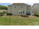 Nice backyard boasts an inviting stone patio with space for seating and a cozy fire pit feature at 11234 Smokethorn Nw Dr, Concord, NC 28027