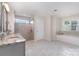 Bright bathroom featuring double sinks, a glass door shower, and a soaking tub at 11234 Smokethorn Nw Dr, Concord, NC 28027