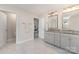 Bright bathroom featuring double sinks and grey cabinetry at 11234 Smokethorn Nw Dr, Concord, NC 28027
