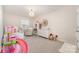 Bright bedroom featuring play furniture, a bed, and a white dresser at 11234 Smokethorn Nw Dr, Concord, NC 28027