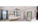 Bright bedroom features a tray ceiling, fan, large mirror, and plush neutral-toned carpeting at 11234 Smokethorn Nw Dr, Concord, NC 28027