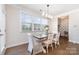 Charming dining room with wood floors, a stylish table and chairs, and large bright windows at 11234 Smokethorn Nw Dr, Concord, NC 28027