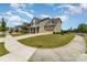 Well-maintained two-story home with a manicured lawn and a long driveway, set in a peaceful neighborhood at 11234 Smokethorn Nw Dr, Concord, NC 28027