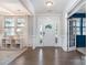 Bright foyer with hardwood floors, decorative moldings, and a view into a sunny front room at 11234 Smokethorn Nw Dr, Concord, NC 28027