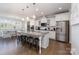 Bright and airy kitchen with a large island, stainless steel appliances, and a view into the dining area at 11234 Smokethorn Nw Dr, Concord, NC 28027