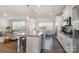 Open-concept kitchen featuring a large island with seating that connects to the living and dining areas at 11234 Smokethorn Nw Dr, Concord, NC 28027