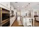 Well-equipped kitchen with stainless steel appliances, a granite island, and a seamless transition to the dining area at 11234 Smokethorn Nw Dr, Concord, NC 28027