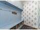Charming mudroom with custom built-in storage and decorative wallpaper at 11234 Smokethorn Nw Dr, Concord, NC 28027