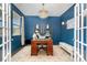 Stylish home office with custom shelving, a chandelier, and plenty of natural light at 11234 Smokethorn Nw Dr, Concord, NC 28027