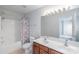 Bathroom showcasing a double sink vanity, large mirror, toilet, and shower/tub combo at 12036 Duke Lancaster Dr, Charlotte, NC 28277