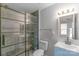 Bathroom showcasing a blue single sink vanity, glass shower door, and large mirror at 12036 Duke Lancaster Dr, Charlotte, NC 28277