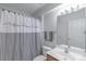 The quaint bathroom features a shower with checkered curtains and a sink with vanity at 12036 Duke Lancaster Dr, Charlotte, NC 28277
